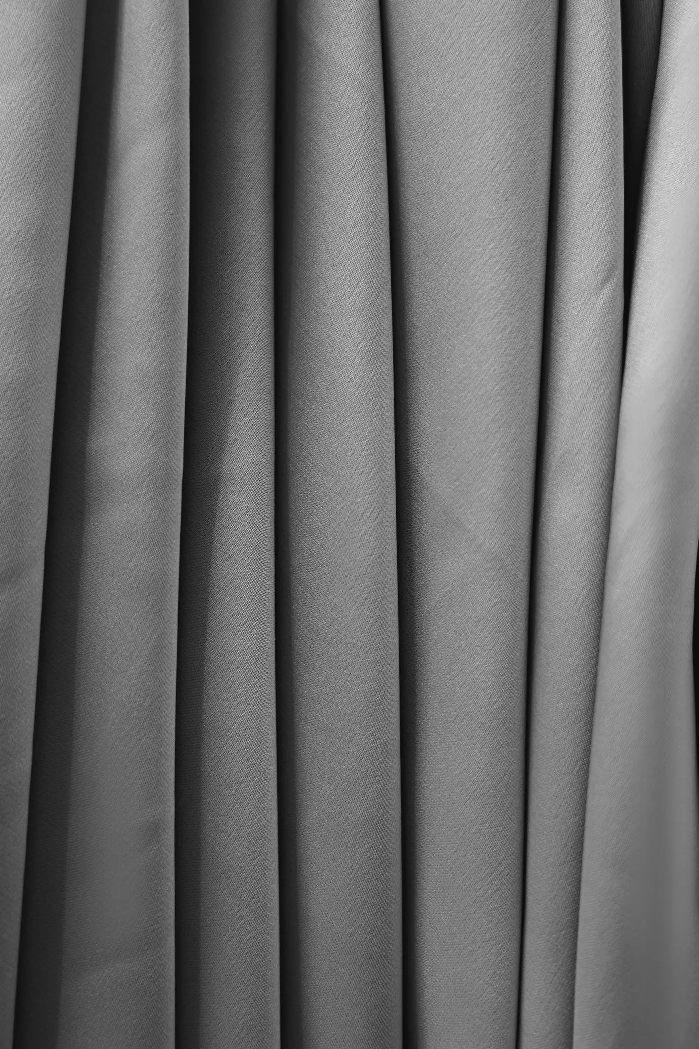 Charcoal blackout curtain fabric falling in deep vertical folds