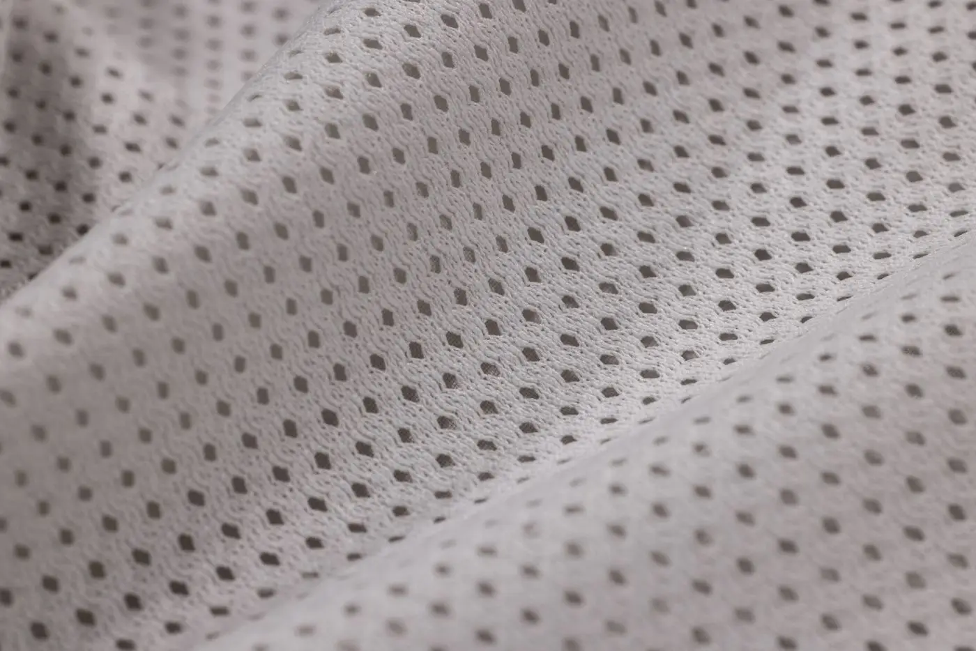 Close-up of a fine perforated mesh fabric