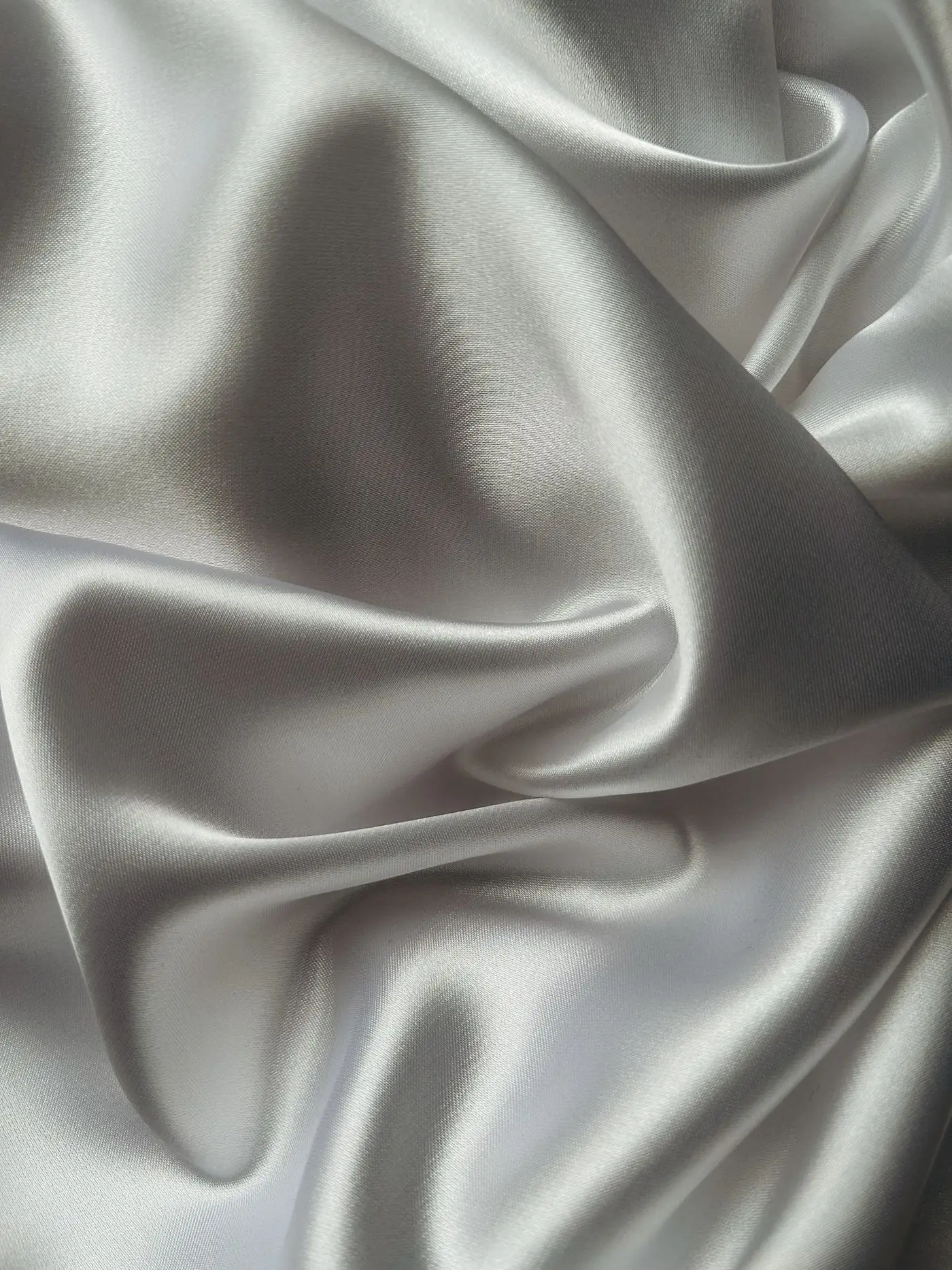 Pale satin fabric swirling into a soft spiral